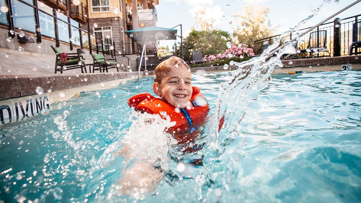 Kid splashing in the pool at Summerland Waterfront Resort & Spa