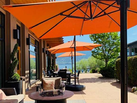 Resort beach with tables, seating, and umbrellas at Summerland Waterfront Resort & Spa