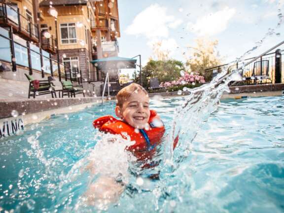 Kid splashing in the pool at Summerland Waterfront Resort & Spa