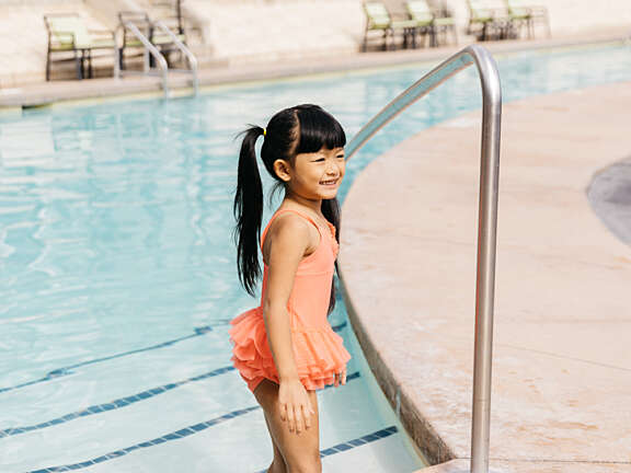 Kid walking into the pool at Summerland Waterfront Resort & Spa