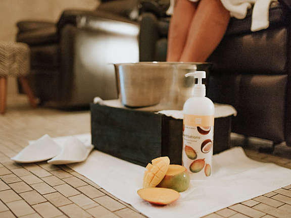 Relaxation setup with foot soak and spa product inside a guest room