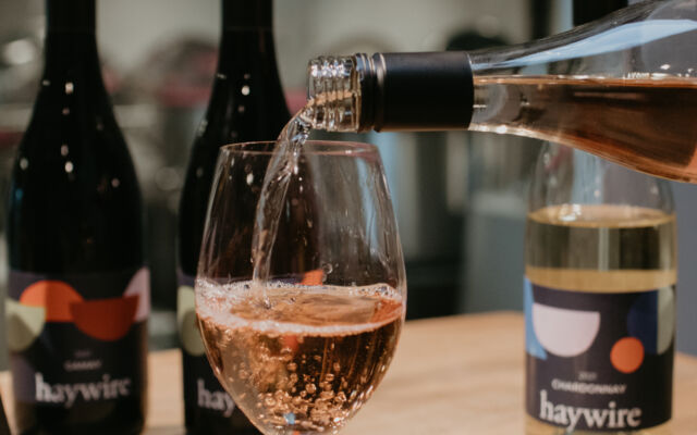 Sparkling Okanagan wine being poured at Haywire Winery near Summerland Waterfront Resort and Spa, showcasing local wine tasting experiences for couples.