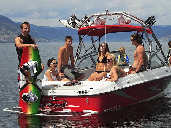 Guests enjoying boating and wakeboarding on Okanagan Lake at Summerland Waterfront Resort