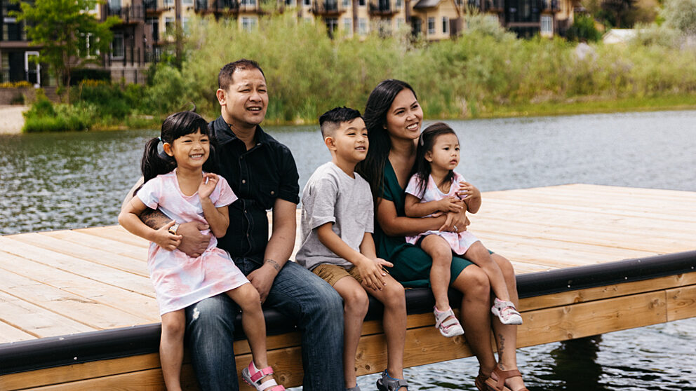 Family sitting on the dock on Okanagan Lake at Summerland Waterfront Resort & Spa